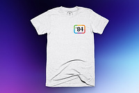 A white shirt with '84 in the pocket corner surrounded by a classic Apple six colors border.