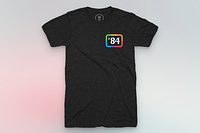 A black shirt with '84 in the pocket corner surrounded by a classic Apple six colors border.