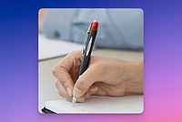 Writing on a pad of paper with a Jetstream pen.
