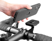 A hand placing an iPhone onto the bike mount.