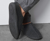 Gray slippers on a man's feet.