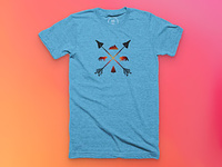 A blue shirt with a crossed arrows, bear, wolf, mountain, and tree design.