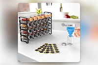 A four stack high spice rack with glass containers, and the spice type written on each lid.